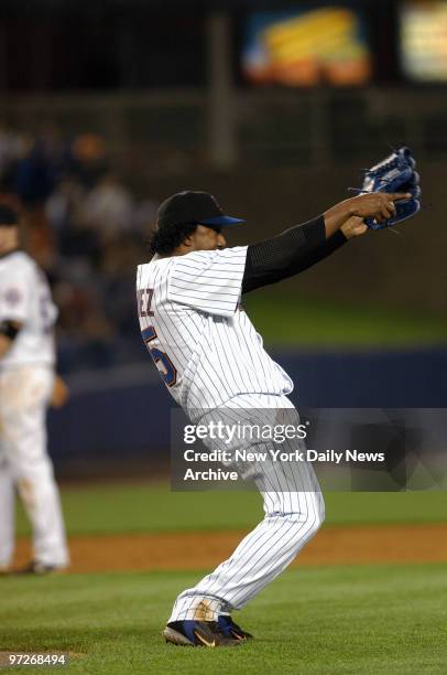 New York Mets' starter Pedro Martinez congratulates outfielder Mike Cameron after Cameron made an impressive, acrobatic catch in the sixth inning of...