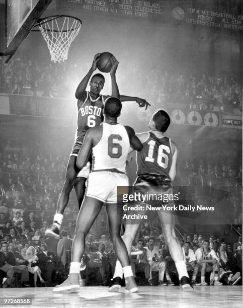 Boston Celtics center Bill Russell [#6] grabs rebound in game against the N.Y. Knicks at Madison Square Garden.