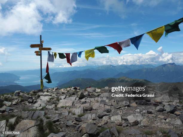 multi colored prayer flags on top of monte tamaro - cairns road stock pictures, royalty-free photos & images