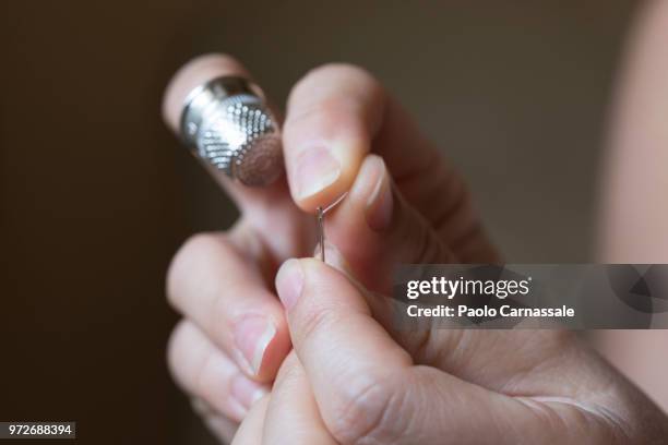 woman  threading sewing needle - thimble stock pictures, royalty-free photos & images