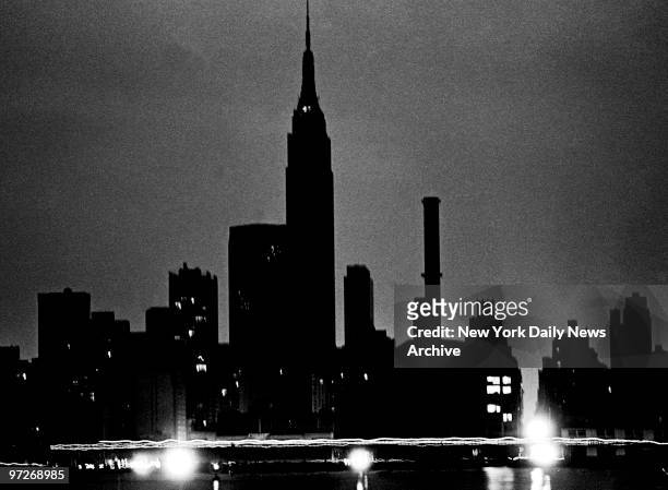 Lights glow in a midtown Waterside Con Ed plant as traffic passes on East Side Drive during a NYC Power failure in the summer of 1977.