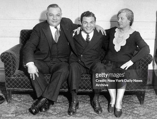 Lightweight boxing champion Tony Canzoneri with his parents, George and Josephine Canzoneri, at Hotel Endicott.