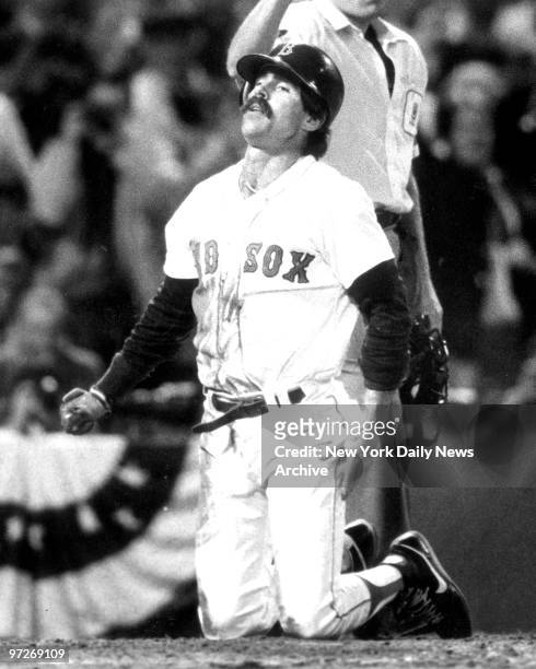 Boston Red Sox' Bill Buckner seems relieved after belly-flopping across plate in 3rd inning of Game Five of the 1986 World Series between the Red Sox...