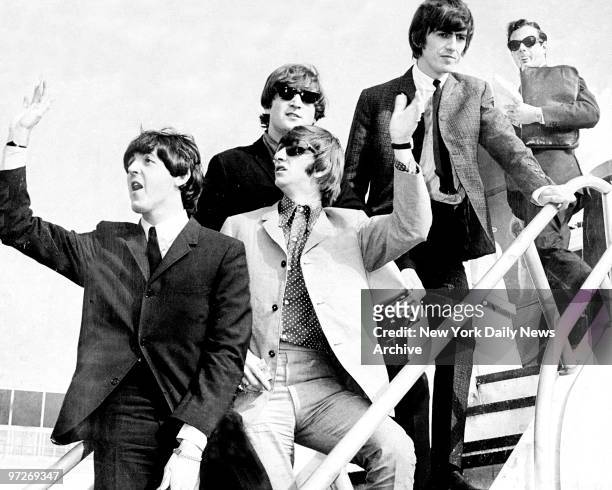 The Beatles, Paul McCartney, Ringo Starr, John Lennon, and George Harrison, followed by their manager Brian Epstein, arriving in New York City for...