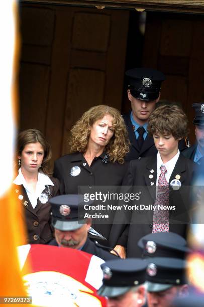 Fire Lt. Howard Carpluk's widow, Debra, their daughter, Paige and son Bradley follow as his coffin is borne out of St. Mark's Episcopal Church in...