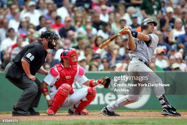 Boston Red Sox catcher Javy Lopez looks on as New York Yankees' catcher Jorge Posada smacks an RBI triple to right center field with the bases loaded...