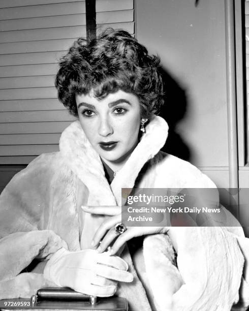 Movie star Elizabeth Taylor displays engagement ring at LaGuardia Field. She stopped off here on her way to London, where she'll wed British Actor...
