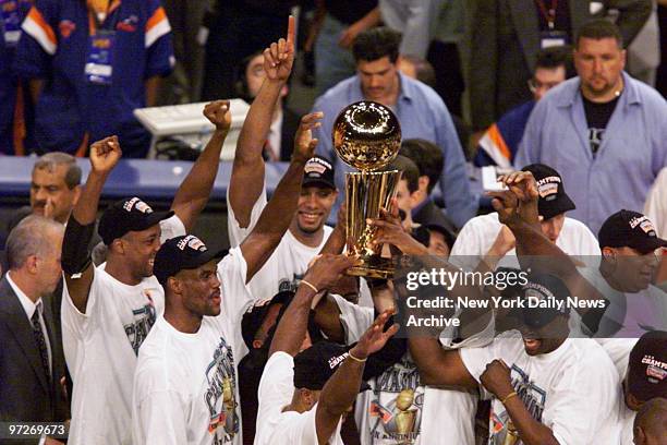 San Antonio Spurs hold up trophy after Spurs beat the New York Knicks, 78-77, in Game 5 to win the NBA Finals at Madison Square Garden.