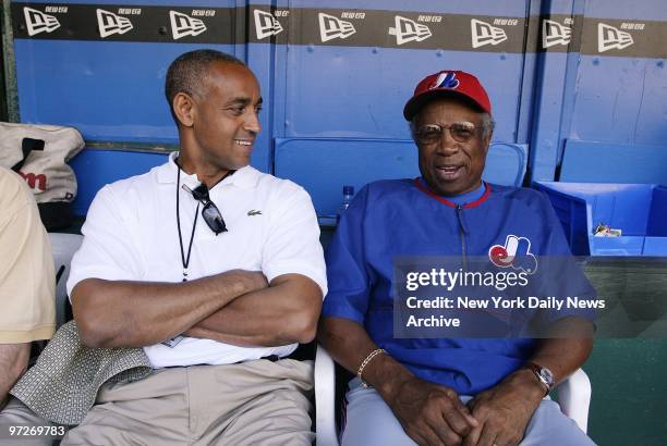 Montreal Expos' general manager and vice president Omar Minaya talks with Expos' manager Frank Robinson in the dugout during practice at Veterans...