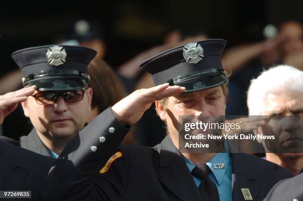 Firefighter Billy Rohl weeps as he and comrades salute at 10:30 a.m. - the time that the second tower of the World Trade Center collapsed - during...