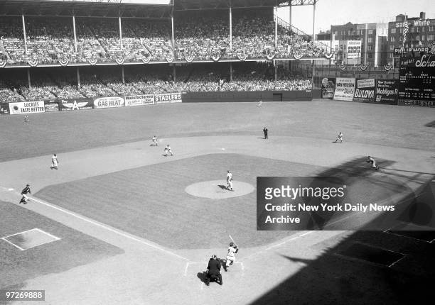 The big moment for the Yankees arrives in second inning as Yogi Berra follows through after swatting grand slam homer, the fifth in World Series...