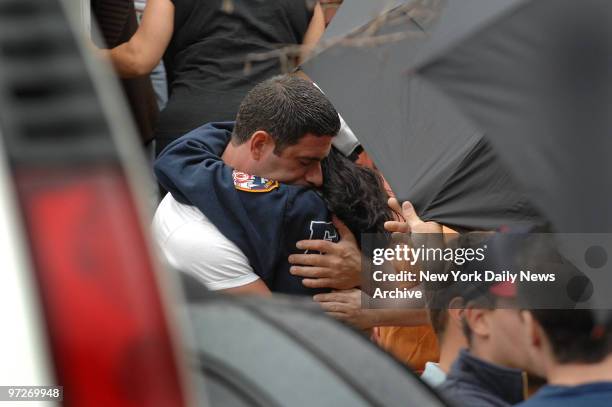 Linda Graffagnino, widow of Firefighter Joe Graffagnino, receives a hug as she's comforted outside her Brooklyn home. Graffagnino and fellow...