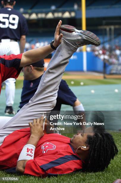 Boston Red Sox outfielder Manny Ramirez listens to his iPod as he stretches before Game 1 of a three-game series against the New York Yankees at...
