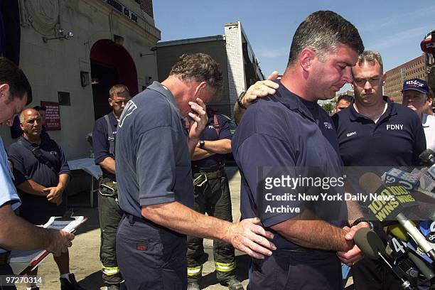 Firefighter John Gaine speaks of lost colleagues as fellow firefighters mourn outside Rescue Co. 4 in Queens. Firefighters Harry Ford and Brian Fahey...