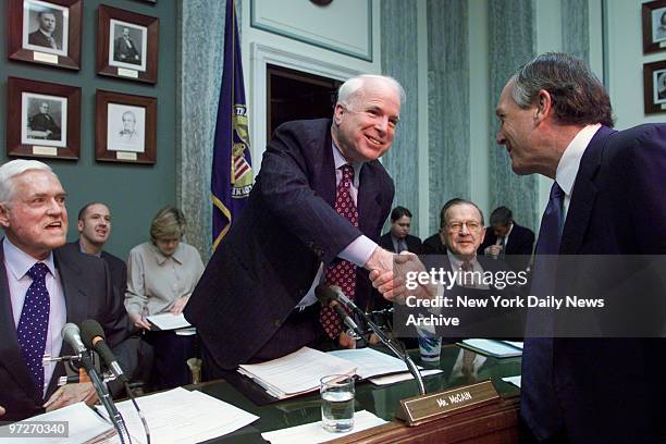 Commerce Secretary-designate Don Evans is welcomed by Sen. John McCain as Sen. Ernest Hollings looks on at Senate Commerce Committee confirmation...