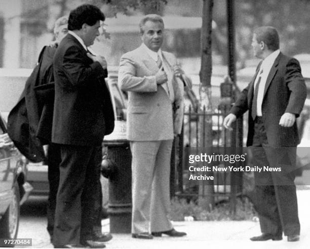 Looking cool even on a hot day, reputed mob boss John Gotti is the center of attention yesterday as he arrives for the funeral of bodyguard Anthony...