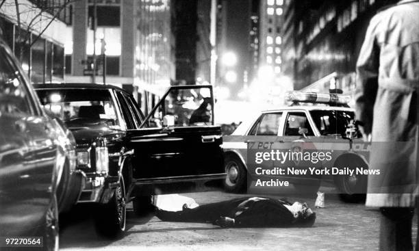 The body of Thomas Bilotti, friend and chauffeur of Mafia boss Paul Castellano, lies in the street after he and Castellano were shot and killed...