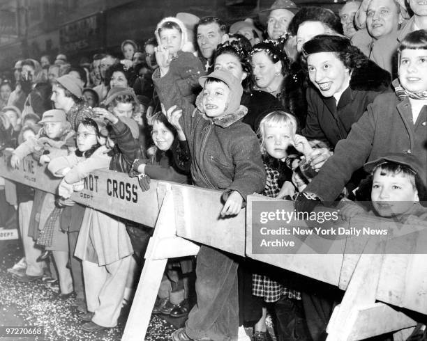 Macy's Thanksgiving Day parade on Broadway shows the expression of joy on children and adults as they view the parade.