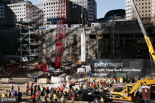 Iron workers move the first 25-ton steel support beam for the Freedom Tower into place at Ground Zero, marking the official beginning of the...