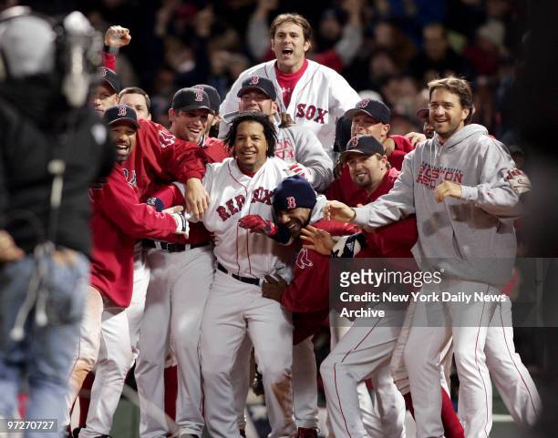 The Boston Red Sox are elated as they wait at the plate for David Ortiz to score after he hit a game-winning, two-run homer in the 12th inning of the...