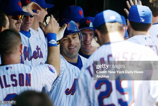 New York Mets' Todd Zeile is congratulated in the dugout after he hit a two-run homer in the first inning of game against the St. Louis Cardinals at...
