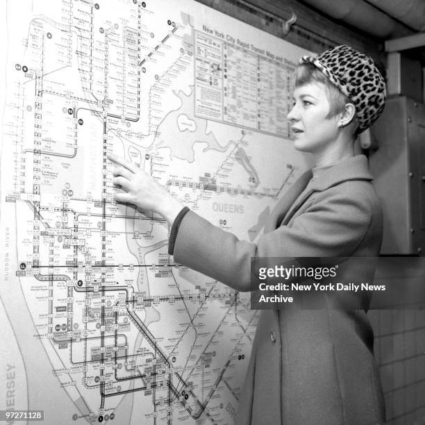 Nancy Baker appears perplexed while studying subway map of new routes going into effect today on BMT and IND systems. But the true test of the pretty...
