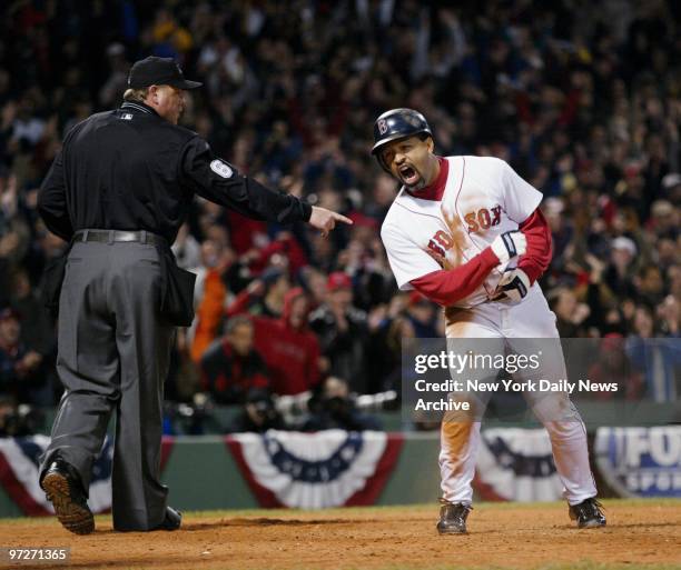 Boston Red Sox's Dave Roberts celebrates after scoring the tying run in the ninth inning of Game 4 of the American League Championship Series against...