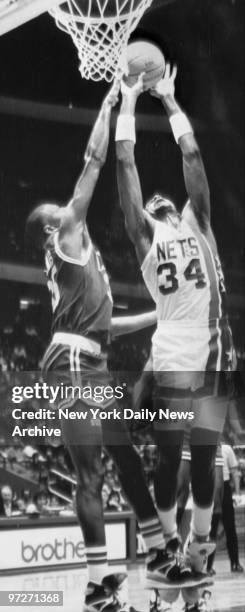Nets' Chris Morris goes up for a layup as Celtics' Reggie Lewis and Kevin McHale try to block.