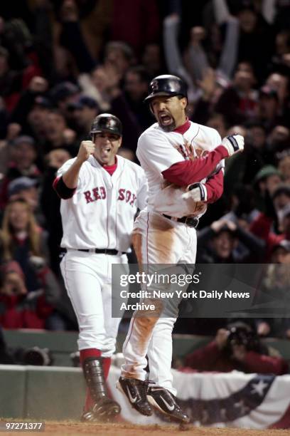 Boston Red Sox's Dave Roberts celebrates after scoring the tying run in the ninth inning of Game 4 of the American League Championship Series against...