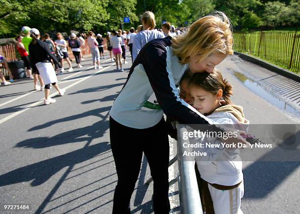 Nancy Tabbs gives her twin daughters, Emily and Halle a hug and a kiss before the start of the third annual Mother's Day Race in Central Park.