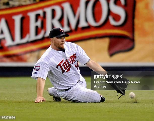 New York Yankees against the Minnesota Twins in Game 3 of the American League Division Series. Jason Kubel can't get to a Robinson Cano RBI single in...