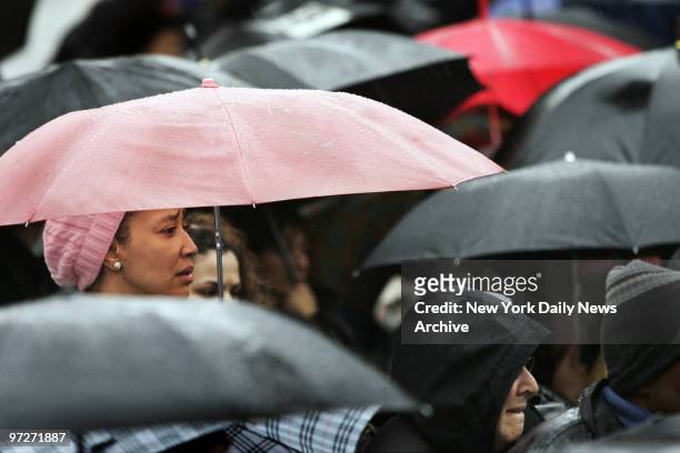 Mourners brave the rain as they stand outside St. Mary's Church on Grand St. Where the funeral service for Nixzmary Brown was being held. The...