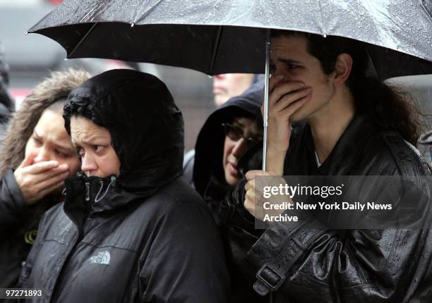 Mourners brave the rain as they stand outside St. Mary's Church on Grand St. Where the funeral service for Nixzmary Brown was being held. The...