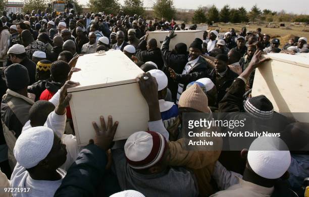 Mourners carry the coffins of the Magassa children at Jersey State Memorial Park where Bandiougou, 11; Mahamadou, 8; Abudubary, 5; Djama, 3; and...