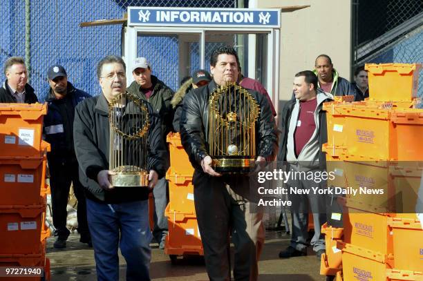 The Yankees move 1977 and 2000 Trophys along with others from the old stadium to new. Eddie Fastook carrying 1977 World Series Trophy and Tom...