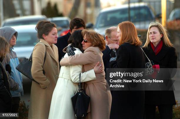 Mourners comfort one another during a wake in Boston, Mass., for Imette St. Guillen on what would have been her 25th birthday. St. Guillen, a...