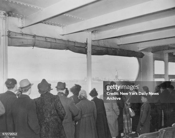 Lined up against the rail, German refugees get their first glimpse of the Statue of Liberty as they arrive aboard the liner Nieuw Amsterdam.