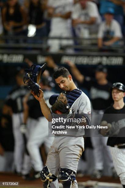 New York Yankees' catcher Jorge Posada reacts as the Florida Marlins celebrate behind him after Derrek Lee scored on a Juan Pierre double in the...