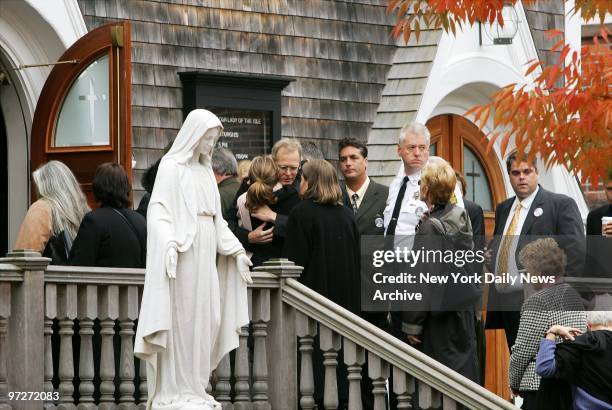 Mourners console Peter Lochtefeld , brother of Elizabeth Lochtefeld, as they enter St. Mary's Church in Nantucket for funeral services for the slain...