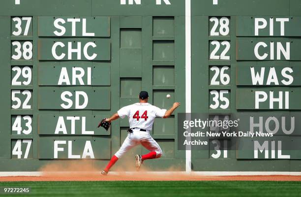 Boston Red Sox's outfielder Gabe Kapler chases down a one-run double hit by New York Yankees' Johnny Damon in front of the famed "Green Monster" wall...