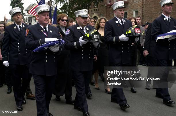 Firefighters from Engine 201 carry flags and helmets as they lead the procession during a memorial service for Christopher Pickford at the Episcopal...