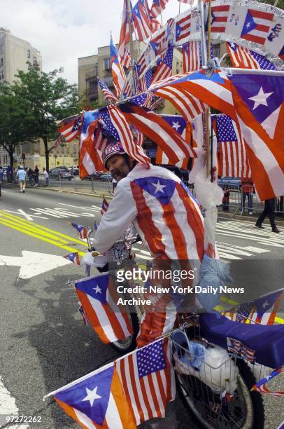 It looks like flag day for Jose Louis Castrodad as he rides his bike at the annual Puerto Rican Day Parade on the Grand Concourse in the Bronx.