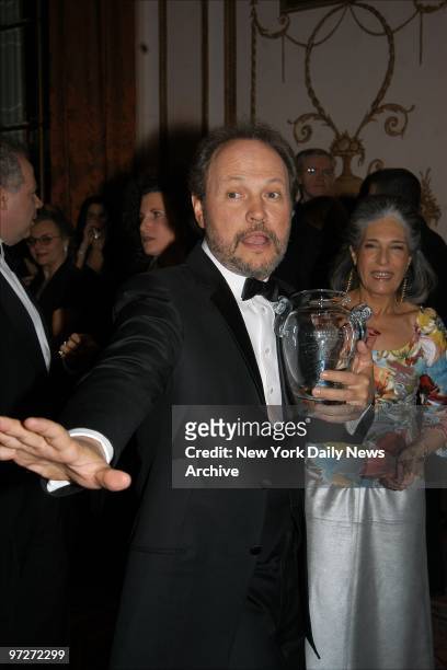 It may not be a Heismann trophy he's holding but Billy Crystal still strikes his best gridiron pose while at the Waldorf-Astoria hotel where he was...