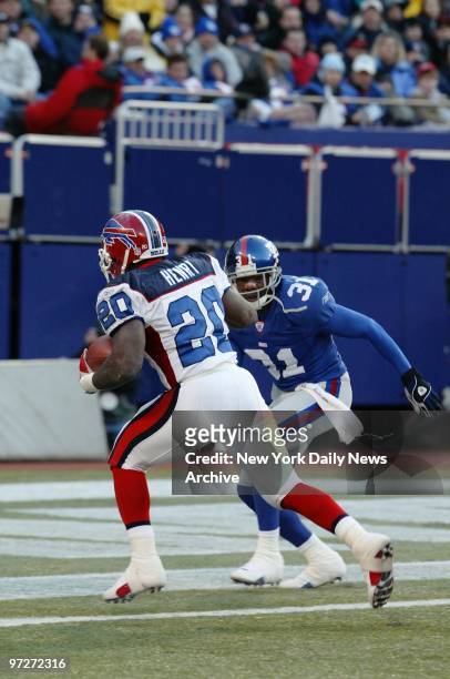 The Buffalo Bills' Travis Henry crosses the goal line after a 13-yard run in the third quarter against the New York Giants at Giants Stadium. The...