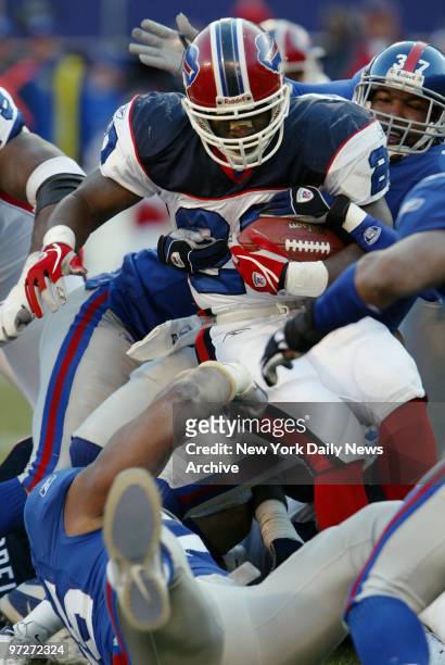 The Buffalo Bills' Travis Henry runs into a traffic jam of New York Giants in a game at Giants Stadium. The Giants lost, 24-7, for their fourth...