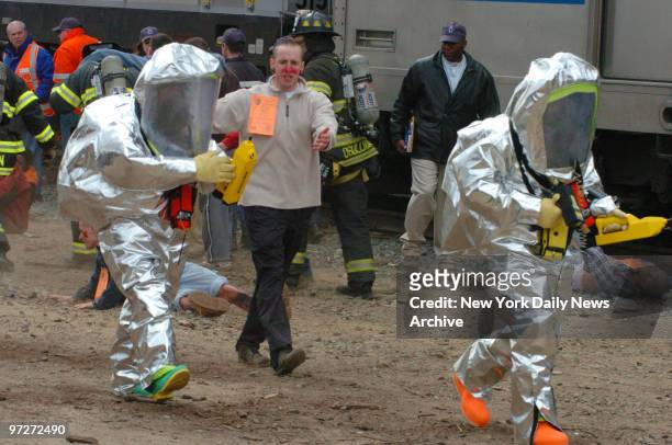 Firefighters in protective radiation suits participate in a disaster drill named Operation Trifecta in Maspeth, Queens. The scenario had over 1,500...