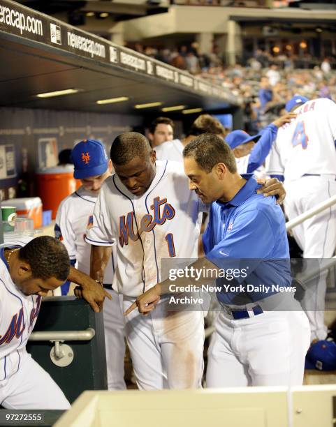 New York Mets vs St Louis Cardinals., Mets Luis Castillo joins Mets' walking wounded after falling down stairs in dugout is being helped by trainer...