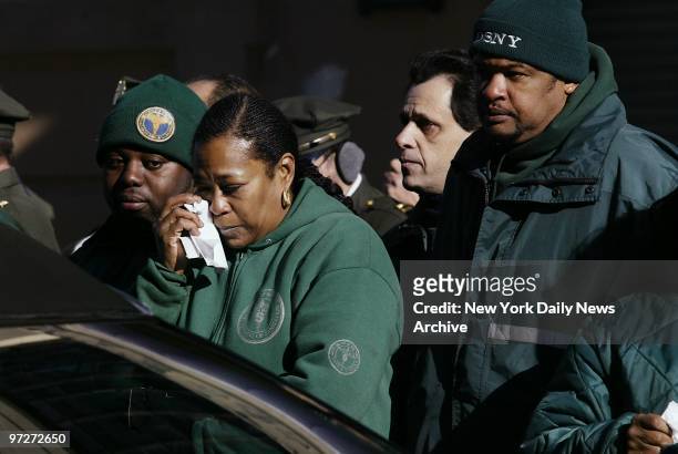 Sanitation workers mourn Eva Barrientos, who lost her life while on the job last week, during funeral ceremonies at Church of the Visitation in Red...