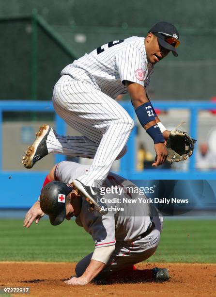 Boston Red Sox's Trot Nixon plows into New York Yankees' second baseman Robinson Cano, causing him to make a wild throw into the stands for an error...