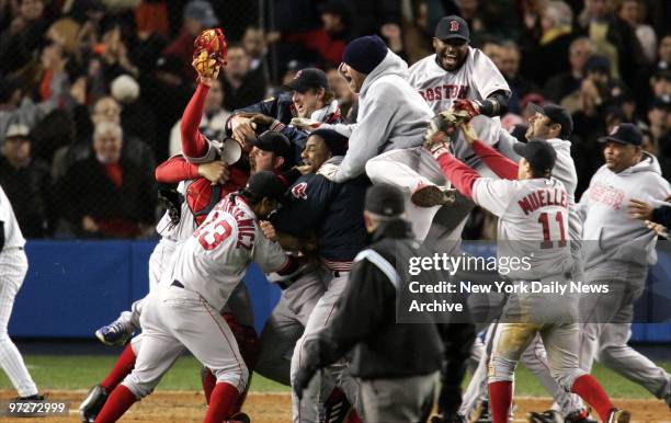 It's bedlam - but a happy kind - as Boston Red Sox players explode with joy after their 10-3 victory over the New York Yankees in Game 7 of the...